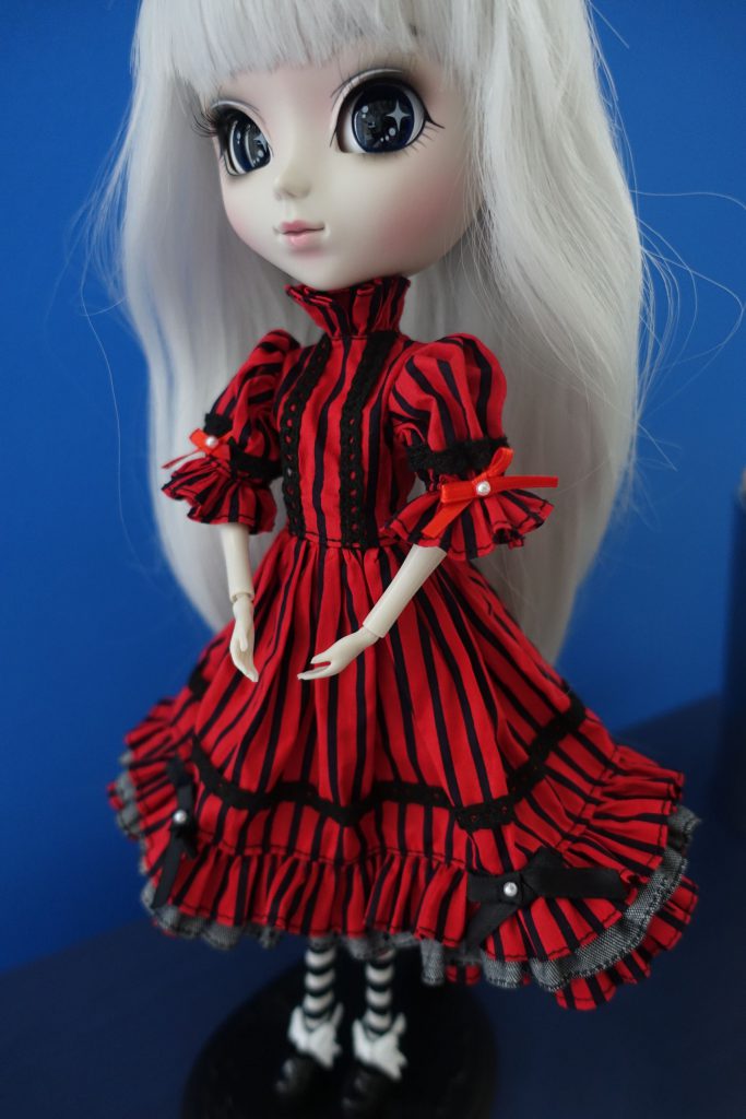 Optical Alice in her red dress without her apron.